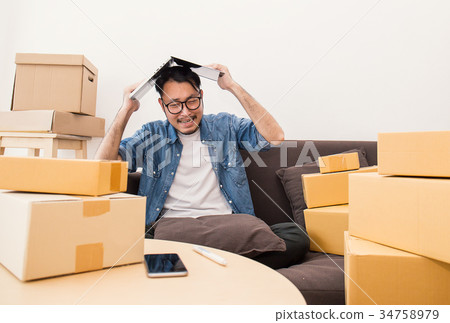 Young Asian man small business owner working Young Asian man small business owner working 34758979