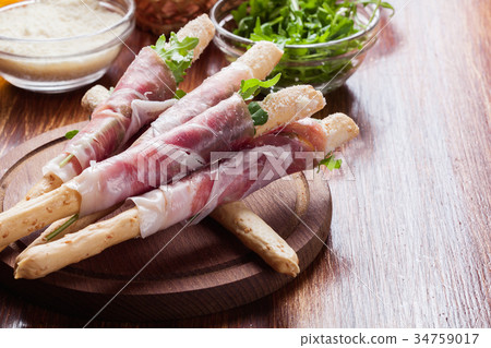 Italian grissini with ham prosciutto, mozzarella 34759017