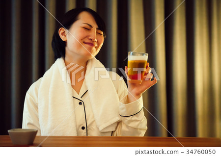Home drinking young woman drinking beer Home drinking young woman drinking beer 34760050
