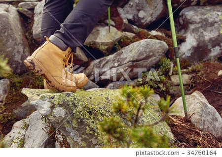 hiking boots close-up. girl tourist steps on the 34760164