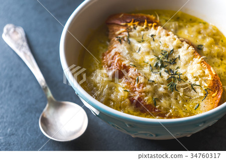 French onion soup with cheese and croutons and a 34760317