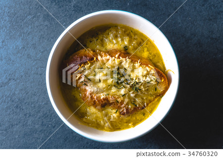 Onion soup with cheese, croutons and thyme in a Onion soup with cheese, croutons and thyme in a 34760320