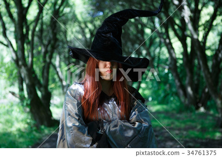 Image of dissatisfied witch in long black hat 34761375