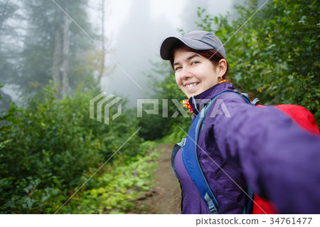 Photo of smiling girl in sportswear in forest 34761477
