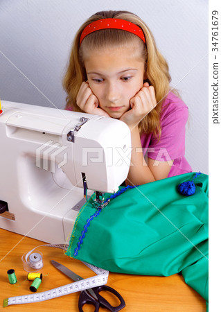 Teen girl frightened by her mistake when sewing 34761679
