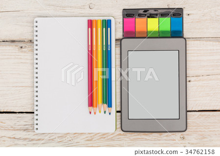 Top view: ebook, notebook and colored pencils Top view: ebook, notebook and colored pencils 34762158