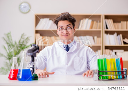 Mad crazy scientist doctor doing experiments in a 34762811