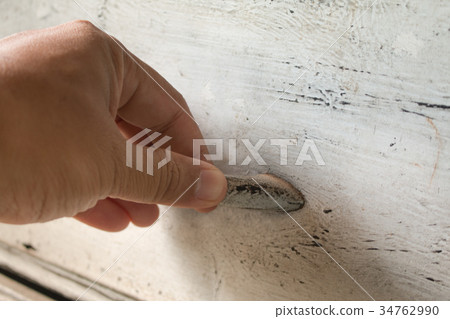 Soft focus of hand open drawer on poor lighting. Soft focus of hand open drawer on poor lighting. 34762990