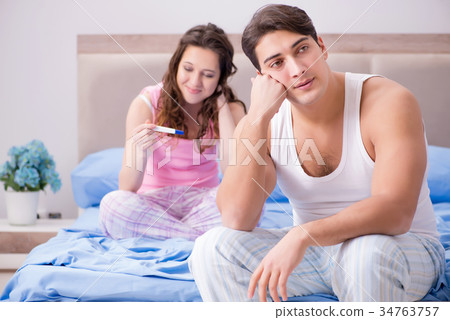 Young family with pregnancy test results Young family with pregnancy test results 34763757
