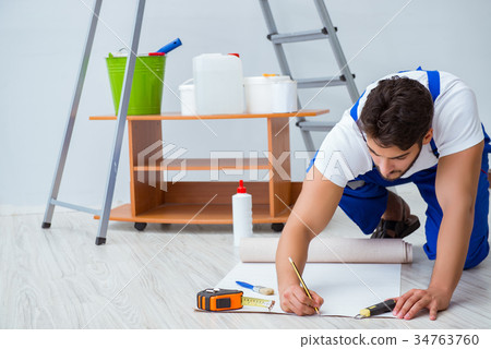 Repairman doing renovation repair in the house Repairman doing renovation repair in the house 34763760