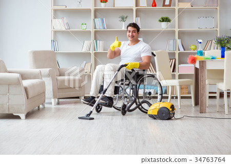 Disabled man with vacuum cleaner at home Disabled man with vacuum cleaner at home 34763764