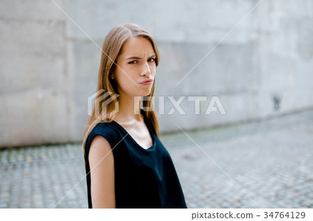 Portrait of young pretty girl with serious face. Portrait of young pretty girl with serious face. 34764129