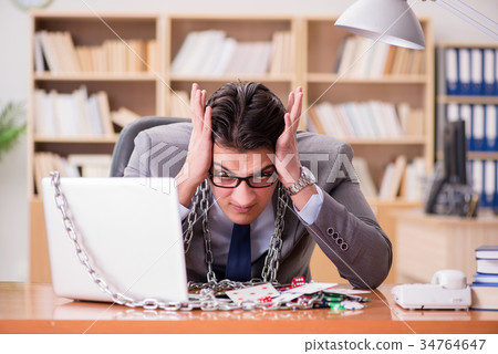 Young businessman addicted to online gambling Young businessman addicted to online gambling 34764647