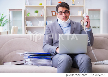 Man in neck brace cervical collar working from Man in neck brace cervical collar working from 34765756