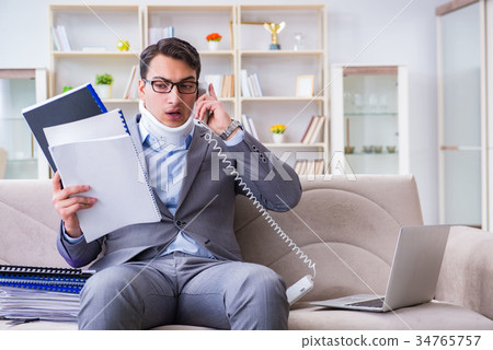 Man in neck brace cervical collar working from Man in neck brace cervical collar working from 34765757