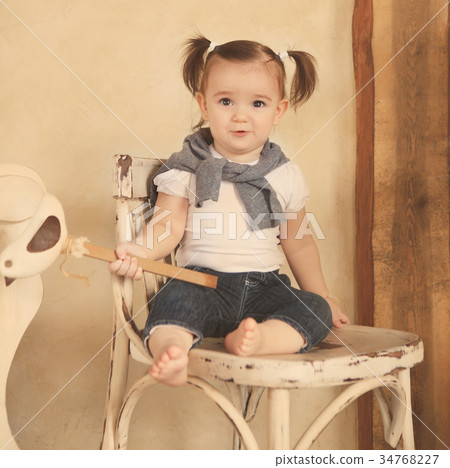 Portrait of the smiling one year old baby girl Portrait of the smiling one year old baby girl 34768227