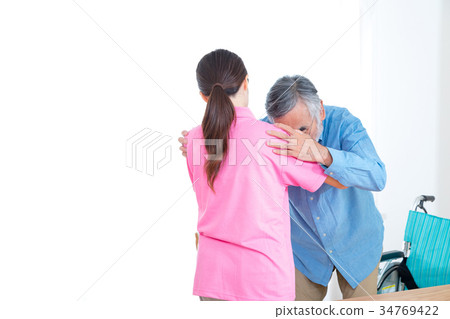 Female carer helping old man Nursing home Day care center Wheelchair Female carer helping old man Nursing home Day care center Wheelchair 34769422