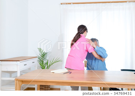 Female carer helping old man Nursing home Day care center Wheelchair Female carer helping old man Nursing home Day care center Wheelchair 34769431
