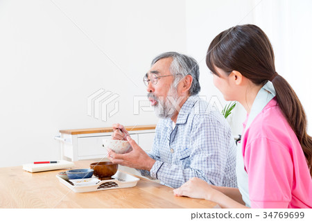 Young carer and grandpa enjoy meal conversation assistance nutrition management nursing home day care center Young carer and grandpa enjoy meal conversation assistance nutrition management nursing home day care center 34769699