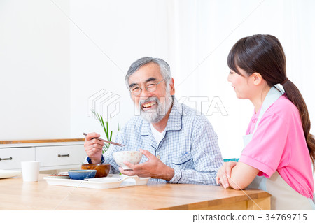 Young carer and grandpa enjoy meal conversation assistance nutrition management nursing home day care center Young carer and grandpa enjoy meal conversation assistance nutrition management nursing home day care center 34769715