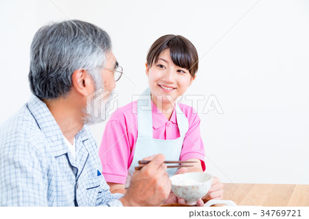 Young carer and grandpa enjoy meal conversation assistance nutrition management nursing home day care center Young carer and grandpa enjoy meal conversation assistance nutrition management nursing home day care center 34769721