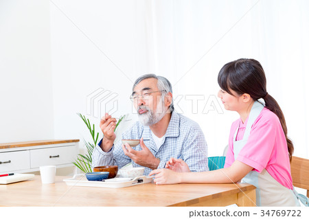 Young carer and grandpa enjoy meal conversation assistance nutrition management nursing home day care center Young carer and grandpa enjoy meal conversation assistance nutrition management nursing home day care center 34769722