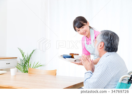 Young carer and grandpa enjoy meal conversation assistance nutrition management nursing home day care center Young carer and grandpa enjoy meal conversation assistance nutrition management nursing home day care center 34769726