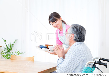 Young carer and grandpa enjoy meal conversation assistance nutrition management nursing home day care center Young carer and grandpa enjoy meal conversation assistance nutrition management nursing home day care center 34769727