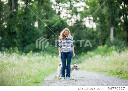 Woman walking with a pet Woman walking with a pet 34770217