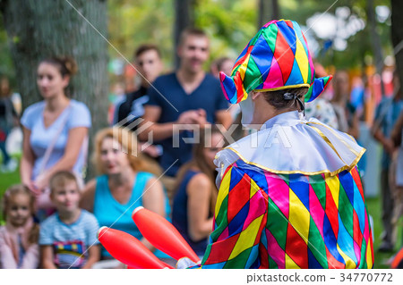 Back view streert juggler in bright clothing Back view streert juggler in bright clothing 34770772