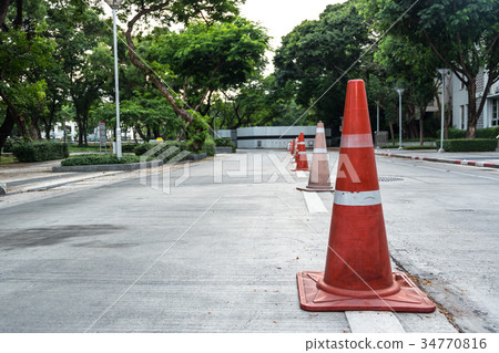 Orange traffic cone on street Orange traffic cone on street 34770816