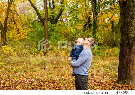 Dad and son in the autumn park Dad and son in the autumn park 34770996