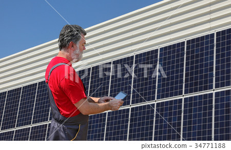 Solar energy, worker and panels Solar energy, worker and panels 34771188