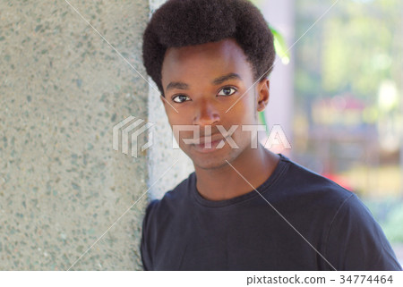 young man around twenty portrait outside 34774464