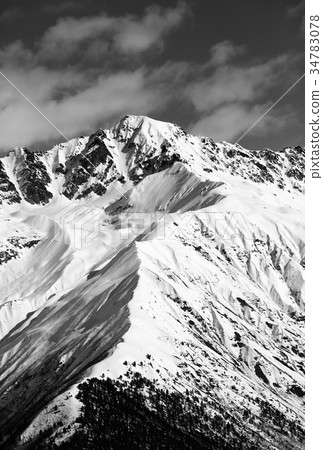 Black and white snow mountain peak at sunny day Black and white snow mountain peak at sunny day 34783078