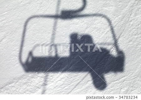 Shadows from chair lift with snowboarder Shadows from chair lift with snowboarder 34783234