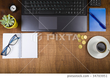 Workplace of businessman with a laptop, top view. Workplace of businessman with a laptop, top view. 34783951