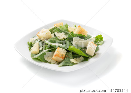 caesar salad in plate on white background 34785344
