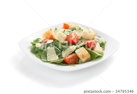 caesar salad in plate on white background 34785346