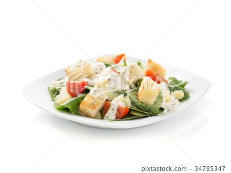 caesar salad in plate on white background 34785347