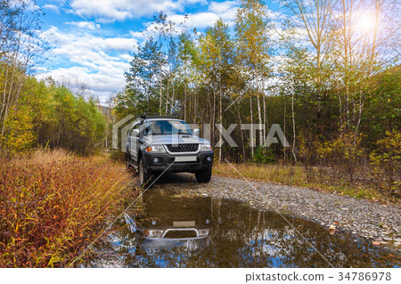 Japanese off road vehicle in autumn forest 34786978