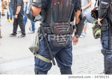 Police officers on duty at a street protest.  34789155