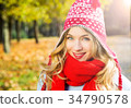 Happy Smiling Woman in Hat on Autumn Background 34790578