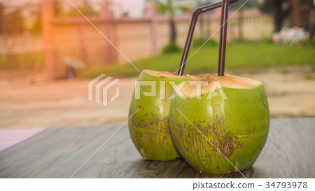 coconut juice and brown tube on wooden table coconut juice and brown tube on wooden table 34793978