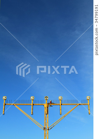 Airport landing lights with airplane approaching Airport landing lights with airplane approaching 34799191