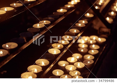 Candles in a dark church 34799486