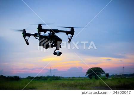 Professional camera drone flying in nature Professional camera drone flying in nature 34800047