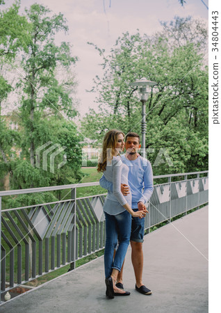 Beautiful young couple playing with a dog husky 34804443