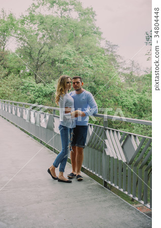 Beautiful young couple playing with a dog husky 34804448