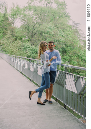 Beautiful young couple playing with a dog husky 34804450